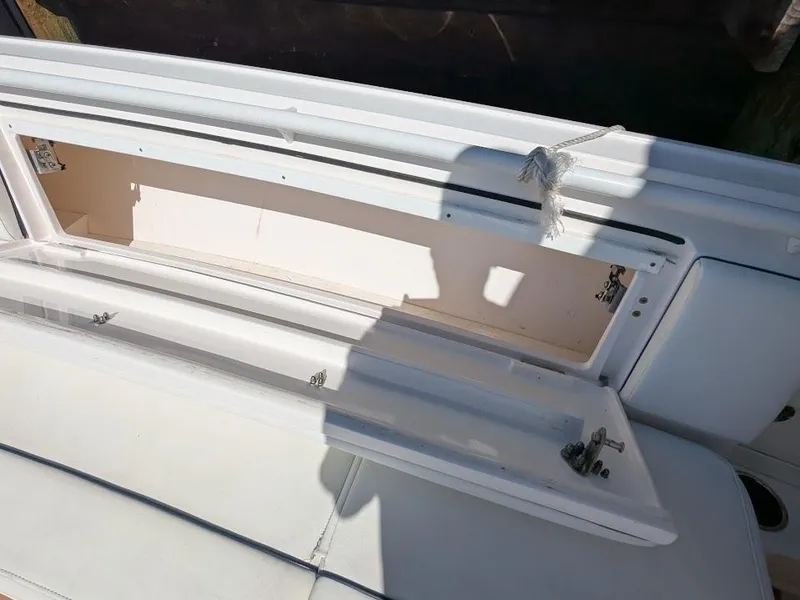 Slide: The Image of Open storage compartment on 2017 Intrepid 327 Center Console boat. - 42