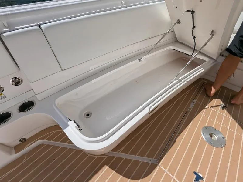 Slide: The Image of Intrepid 327 Center Console 2019, open storage compartment, teak deck, 2017 model. - 44