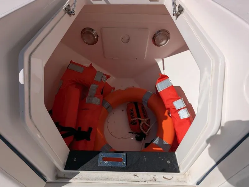 Slide: The Image of Storage compartment with life jackets and ring buoy on Intrepid 327 Center Console boat. - 45