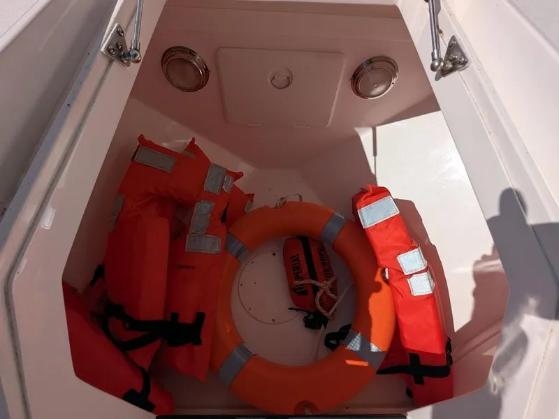 Slide: The Image of Storage compartment with life jackets and ring buoy on Intrepid 327 Center Console boat. - 46