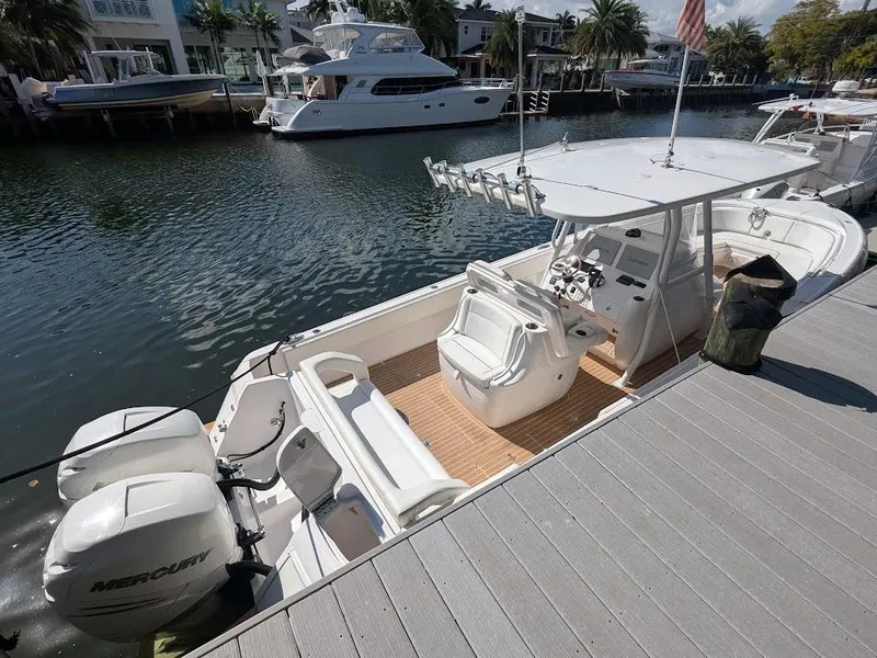 Slide: The Image of Intrepid 327 Center Console 2017 boat docked, featuring upgraded Mercury motors. - 5