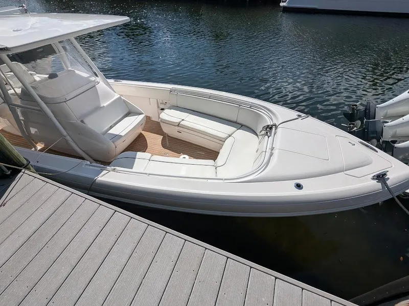 Slide: The Image of Intrepid 327 Center Console boat docked, 2019 model with upgraded motors, side view. - 7