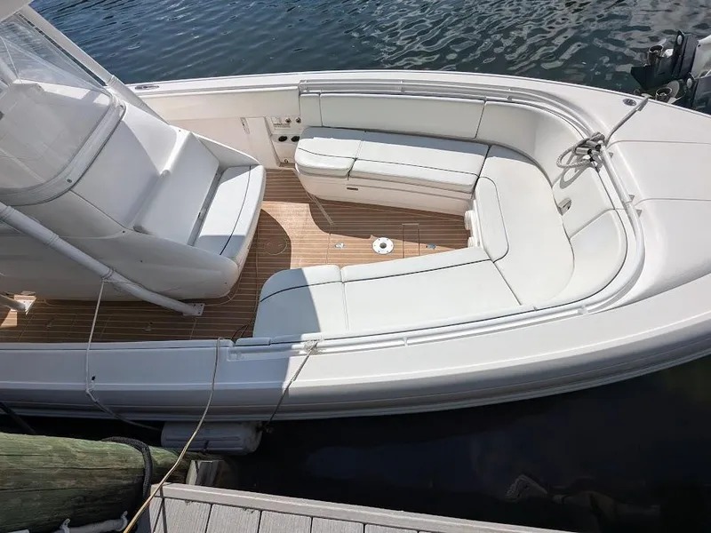 Slide: The Image of Intrepid 327 Center Console 2019, upgraded motors, 2017 model, sleek white seating, docked. - 9