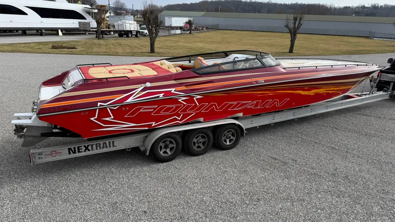 Slide: The Image of 2007 Fountain 42 Lightning speedboat on trailer, red with bold graphics, parked outdoors. - 10
