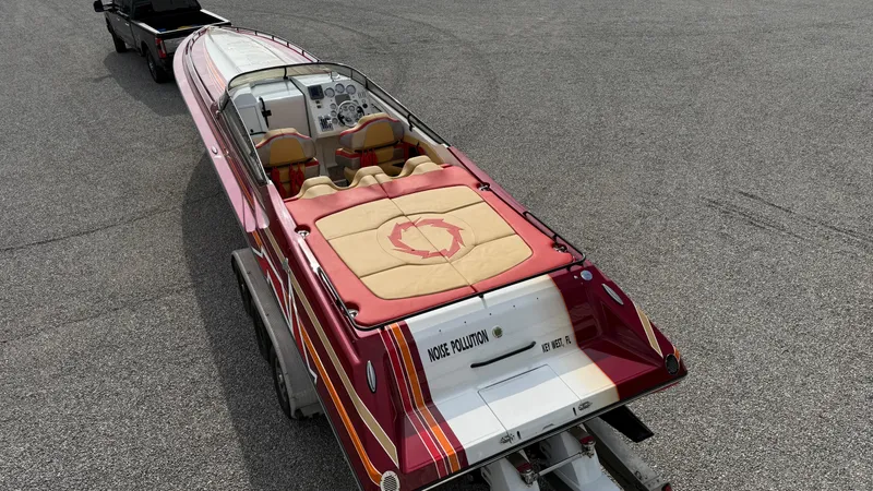 Slide: The Image of 2007 Fountain 42 Lightning speedboat on trailer, red and white design, parked on asphalt. - 14