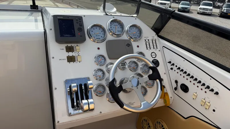 Slide: The Image of Dashboard of a 2007 Fountain 42 Lightning boat with gauges and steering wheel. - 18