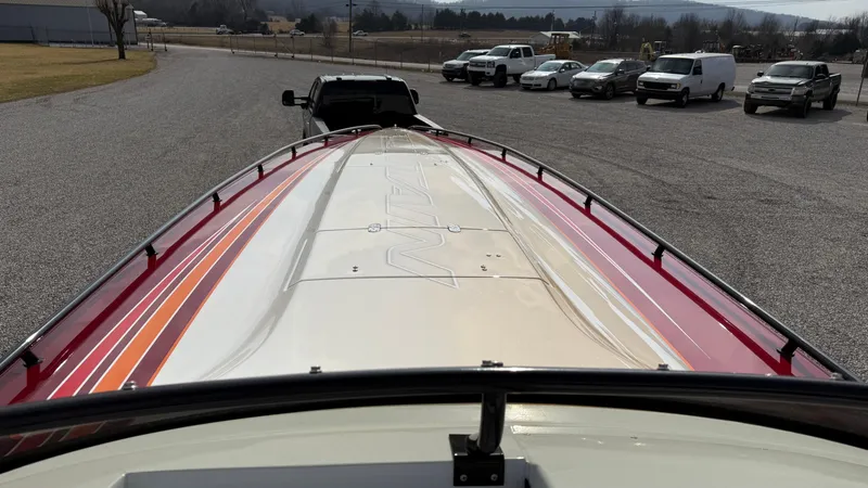 Slide: The Image of 2007 Fountain 42 Lightning boat on trailer, parked in a lot with several vehicles. - 24