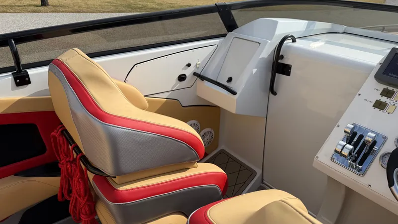 Slide: The Image of 2007 Fountain 42 Lightning boat interior with red and beige seating and control panel. - 25