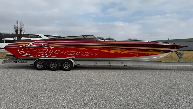 Slide: The Image of 2007 Fountain 42 Lightning speedboat on trailer, red and orange design, parked outdoors. - 5