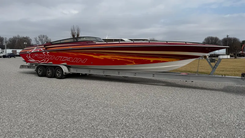 Slide: The Image of 2007 Fountain 42 Lightning speedboat on trailer, red and yellow design, parked outdoors. - 6