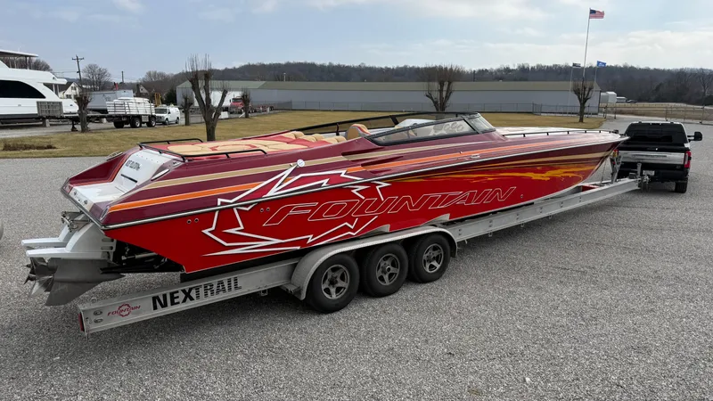 Slide: The Image of 2007 Fountain 42 Lightning speedboat on trailer, vibrant red design, parked outdoors. - 7