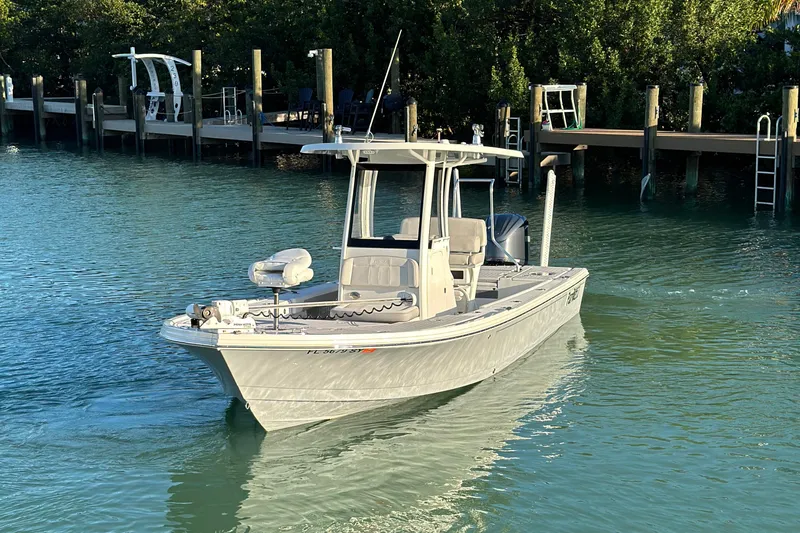 Slide: The Image of 2021 Parker 2600 SH boat cruising on calm water near a dock. - 1