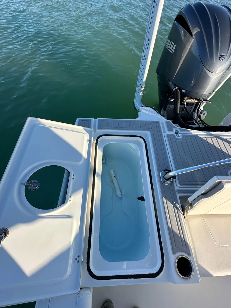 Slide: The Image of Parker 2600 SH 2021 boat with Yamaha engine, featuring a livewell on deck. - 13