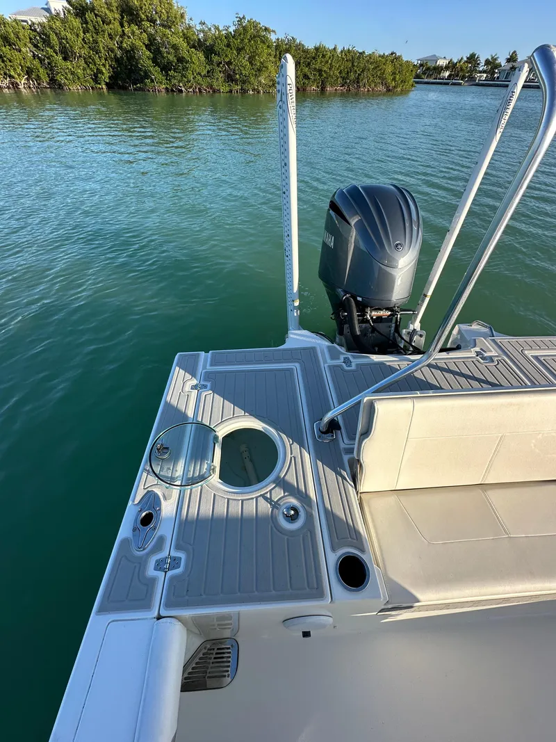 Slide: The Image of 2021 Parker 2600 SH boat with outboard motor on calm water. - 14