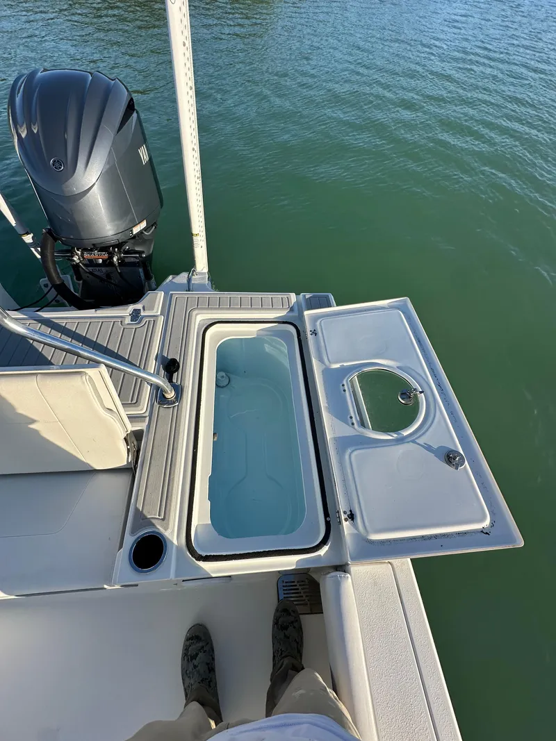 Slide: The Image of Parker 2600 SH boat, 2021 model, featuring an open hatch and outboard motor on calm water. - 15