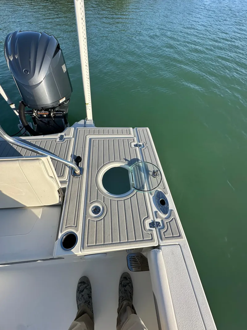 Slide: The Image of Parker 2600 SH boat deck, 2021 model, with outboard motor on calm water. - 16