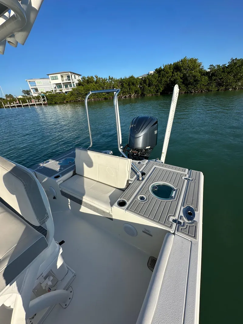 Slide: The Image of 2021 Parker 2600 SH boat on water, featuring a sleek deck and modern outboard motor. - 17