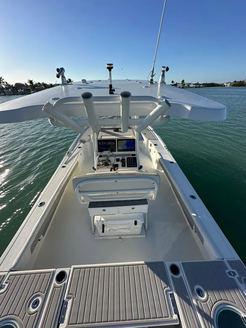 Slide: The Image of 2021 Parker 2600 SH boat on water, featuring a sleek console and spacious deck. - 18