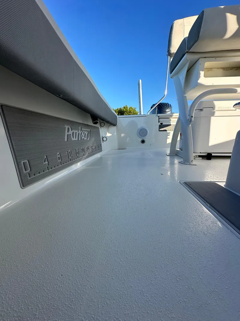 Slide: The Image of 2021 Parker 2600 SH boat interior with seating and measurement markings, under clear blue sky. - 19
