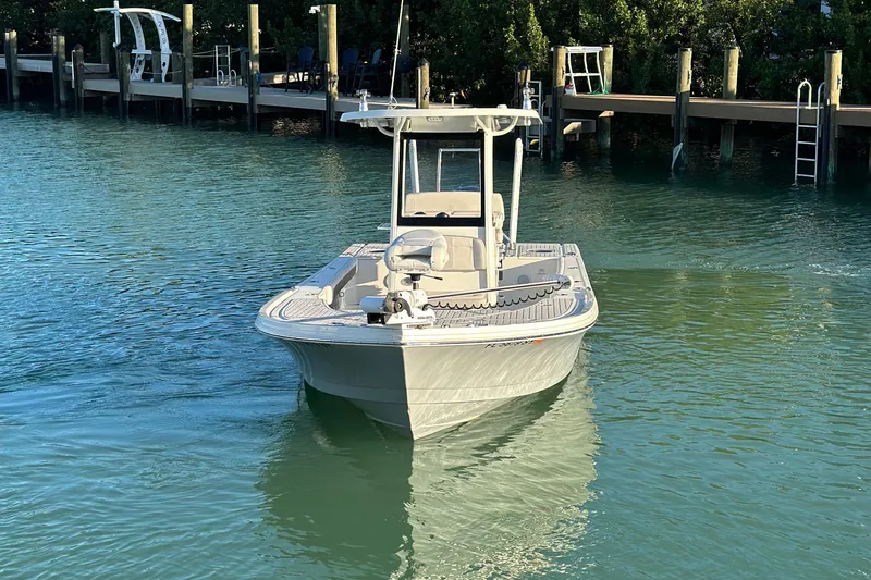 Slide: The Image of 2021 Parker 2600 SH boat on calm water near a dock. - 2
