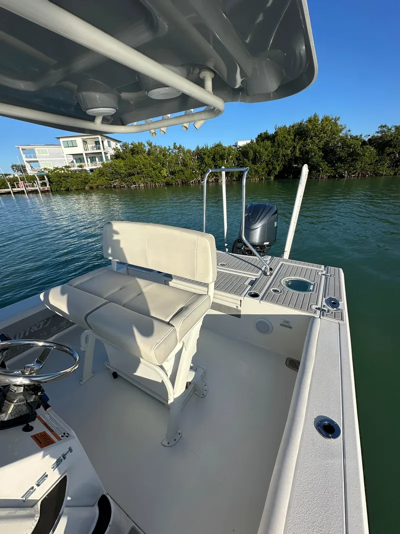 Slide: The Image of 2021 Parker 2600 SH boat on water, featuring a sleek design and comfortable seating. - 21