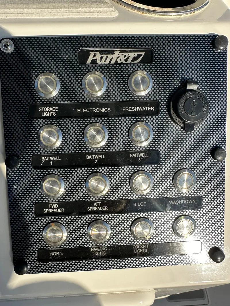 Slide: The Image of Control panel of a 2021 Parker 2600 SH boat with labeled switches and buttons. - 24