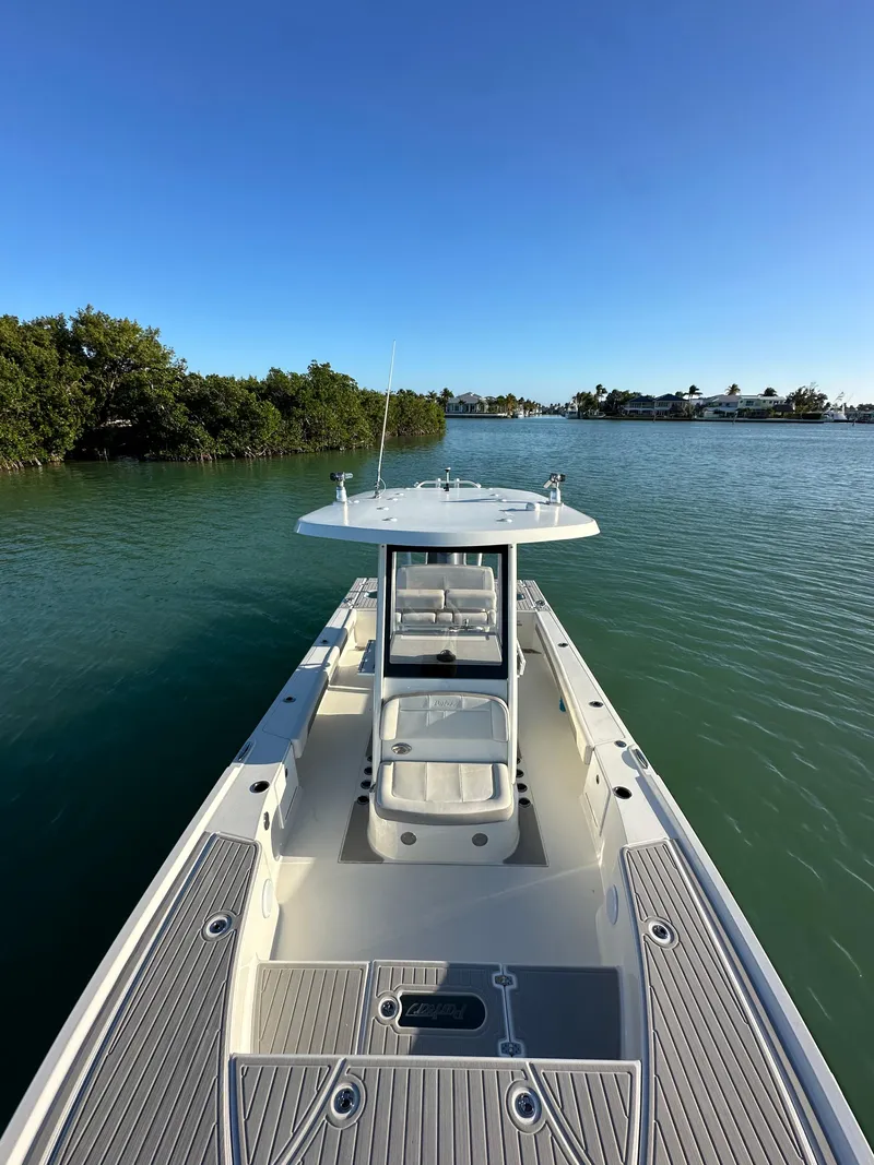 Slide: The Image of 2021 Parker 2600 SH boat on calm water with clear blue sky. - 27