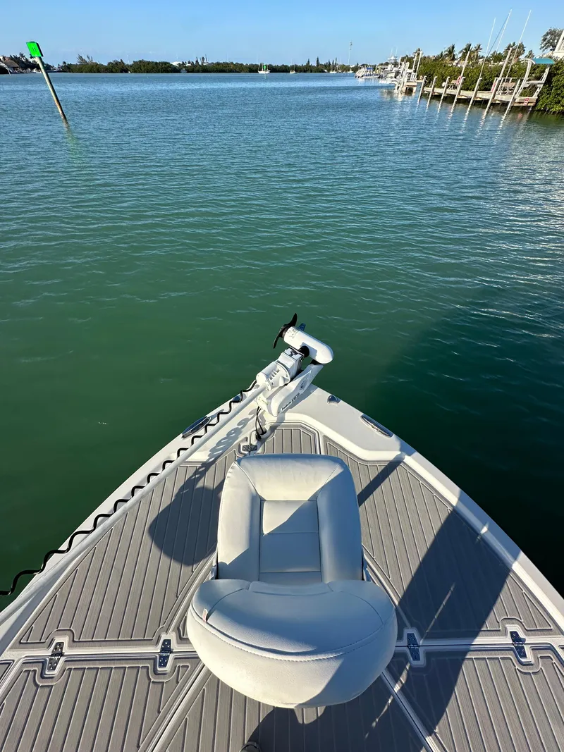 Slide: The Image of 2021 Parker 2600 SH boat on calm water, featuring a sleek deck and comfortable seating. - 30