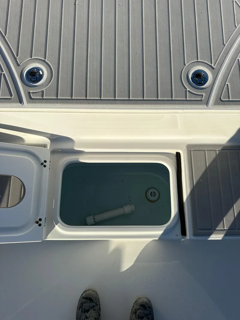 Slide: The Image of Parker 2600 SH 2021 boat deck with open storage compartment. - 32