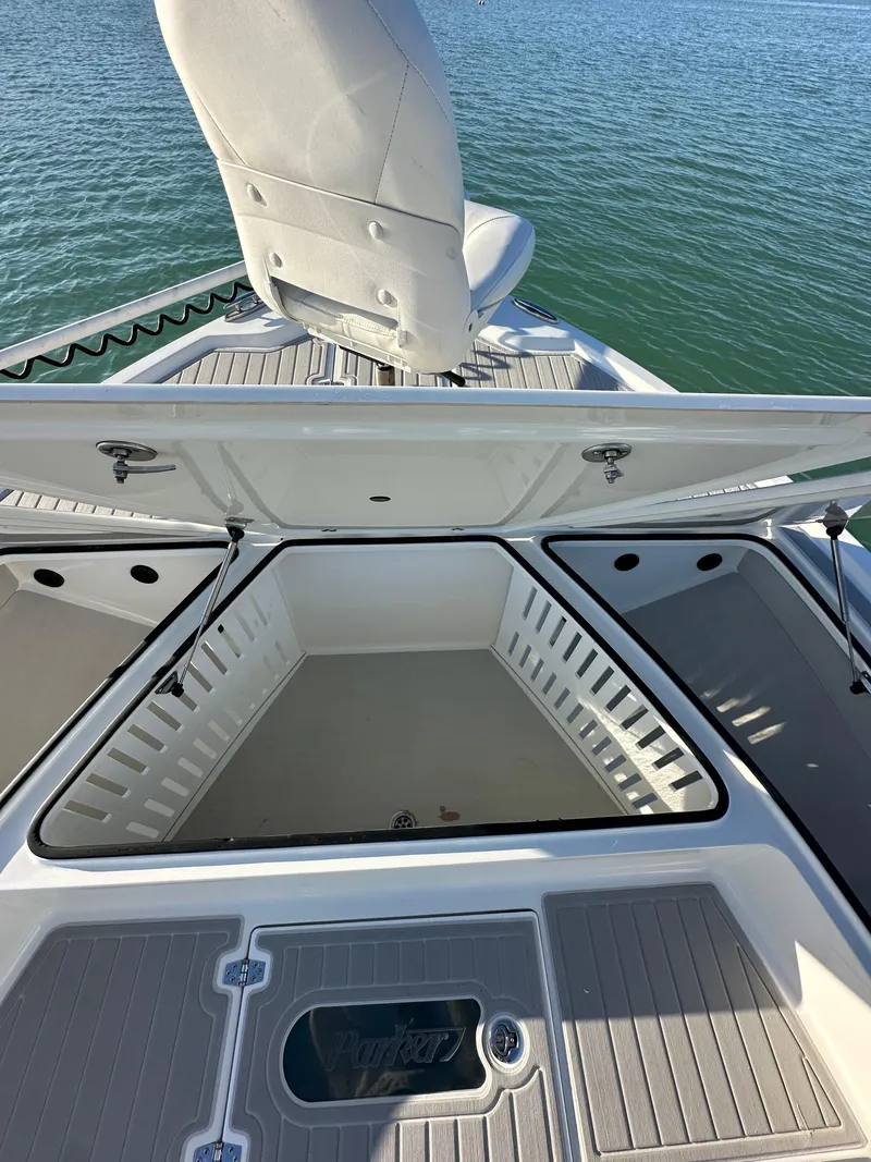 Slide: The Image of 2021 Parker 2600 SH boat with open storage compartment on calm water. - 34