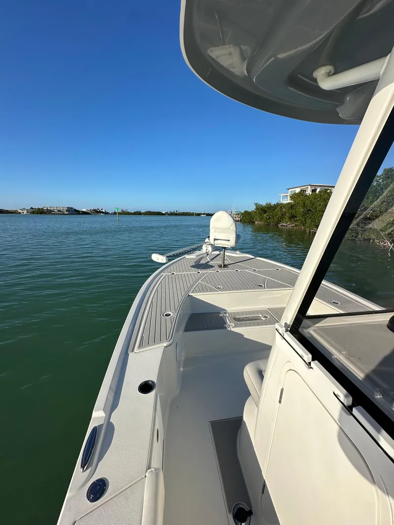 Slide: The Image of 2021 Parker 2600 SH boat on calm water under clear blue sky. - 39