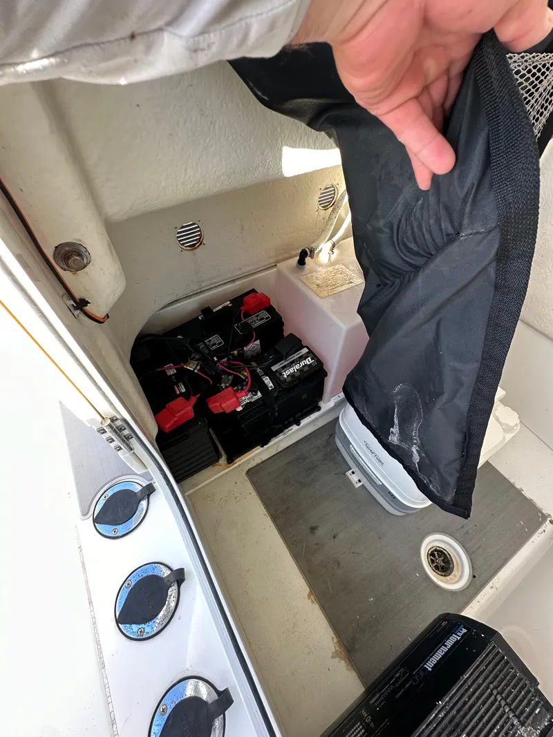 Slide: The Image of 2021 Parker 2600 SH boat battery compartment with protective cover. - 42