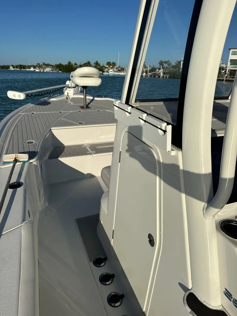 Slide: The Image of 2021 Parker 2600 SH boat on water, showcasing sleek design and spacious deck. - 45