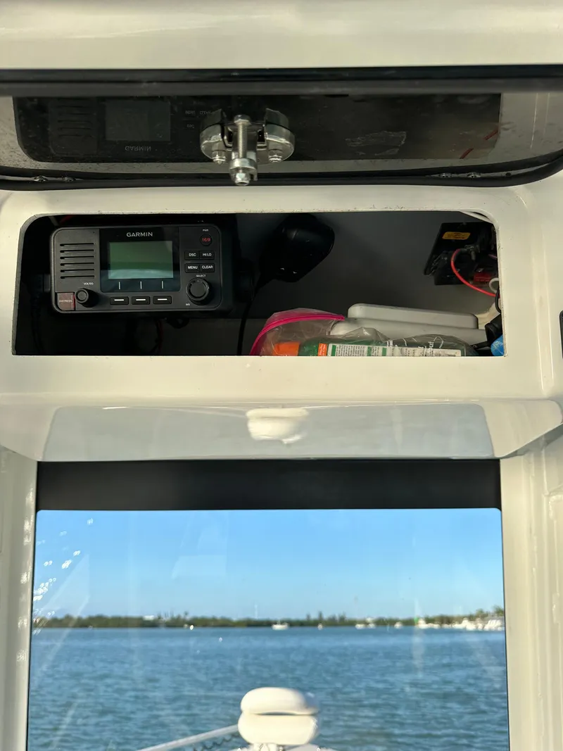 Slide: The Image of 2021 Parker 2600 SH boat interior with radio equipment and ocean view. - 46