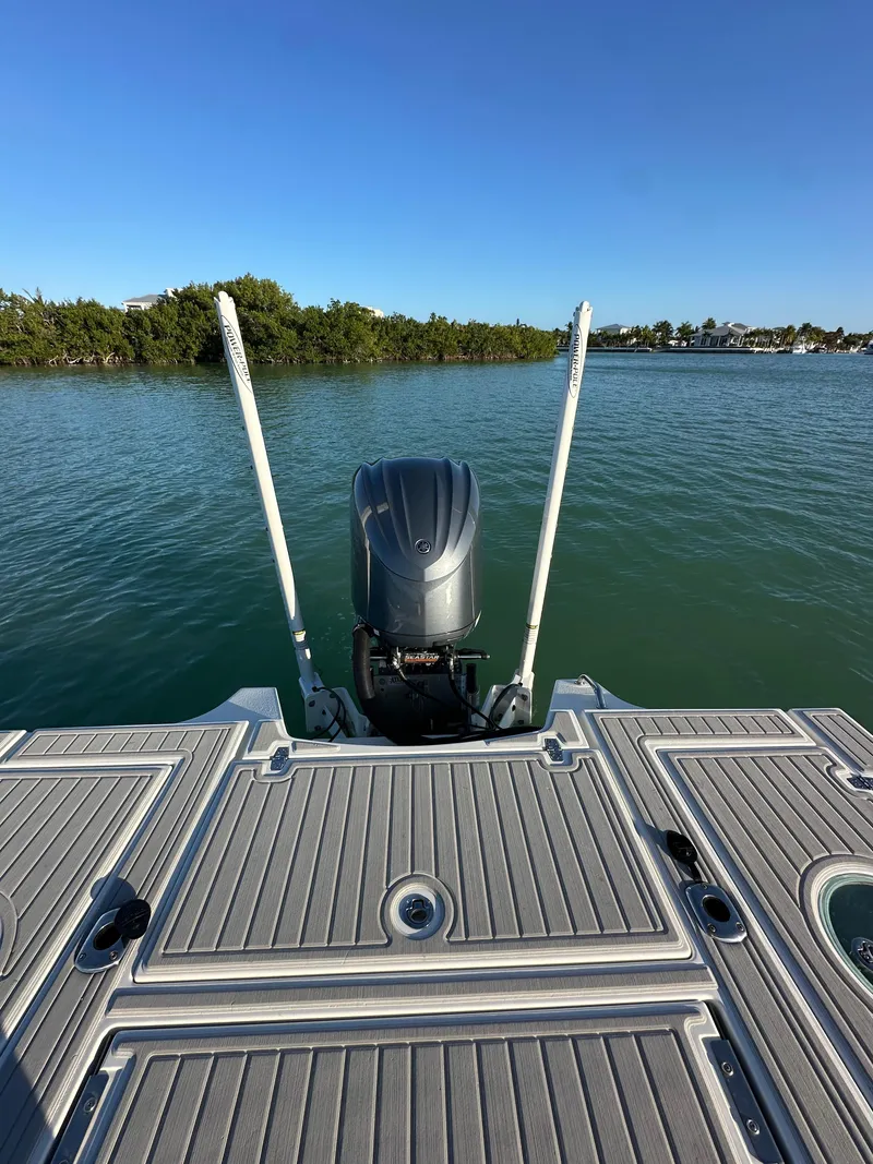 Slide: The Image of Parker 2600 SH boat, 2021 model, on calm water with clear blue sky. - 9