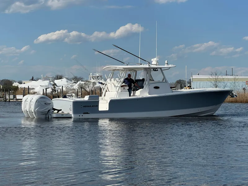Slide: The Image of 2024 Regulator 37 boat on calm water under a blue sky. - 13