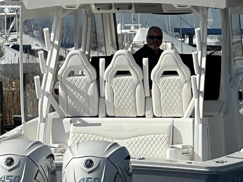 Slide: The Image of 2024 Regulator 37 boat with white seating and dual Yamaha 450 engines. - 17