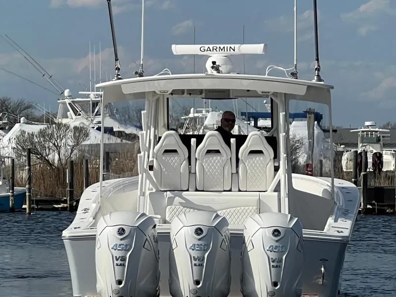 Slide: The Image of 2024 Regulator 37 boat with triple 425 Yamaha engines, docked in a marina. - 19