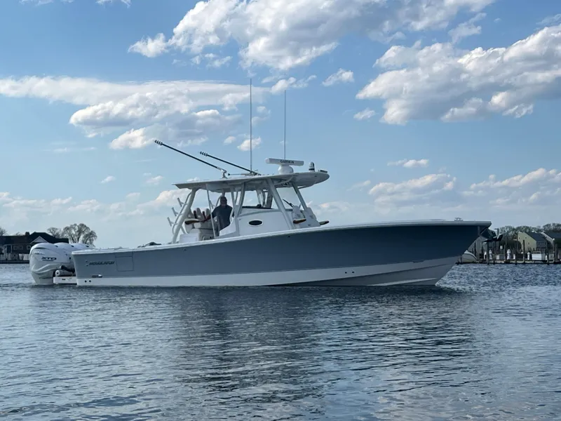 Slide: The Image of 2024 Regulator 37 boat on calm water under a partly cloudy sky. - 23