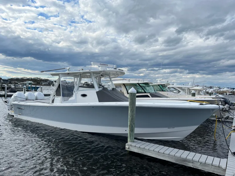 Slide: The Image of 2024 Regulator 37 boat docked under cloudy skies. - 26