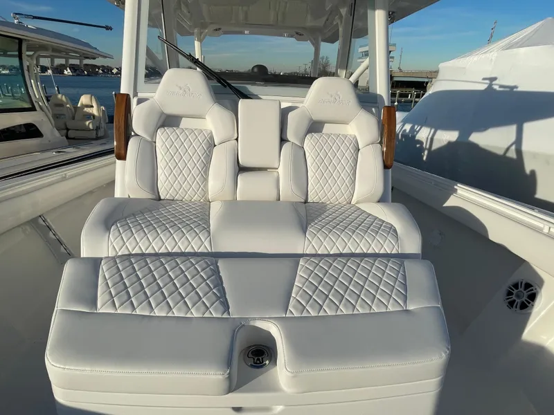Slide: The Image of 2024 Regulator 37 boat with luxurious white quilted seating. - 29