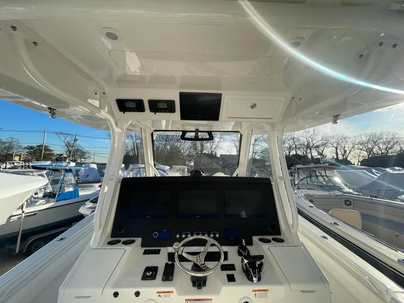 Slide: The Image of 2024 Regulator 37 boat dashboard with modern controls and steering wheel. - 31