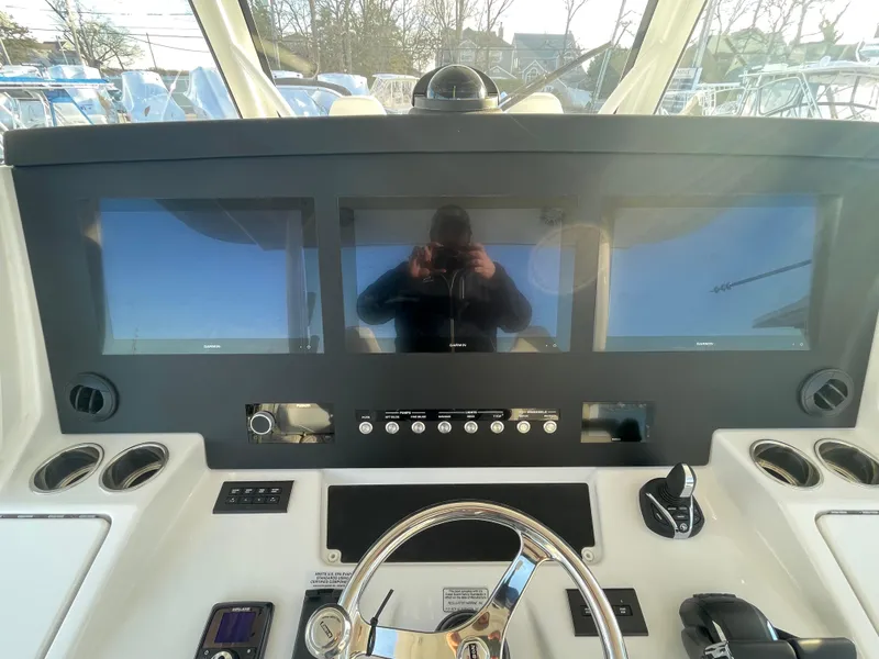 Slide: The Image of 2024 Regulator 37 boat dashboard with modern navigation screens and controls. - 32