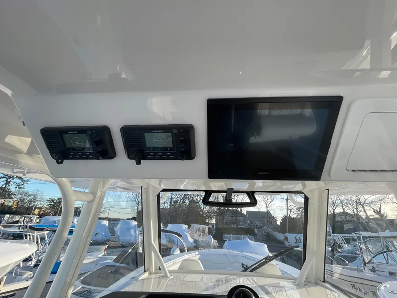Slide: The Image of 2024 Regulator 37 boat dashboard with electronic displays and controls. - 33