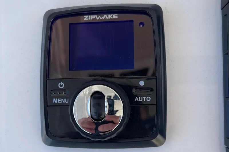 Slide: The Image of Zipwake control panel on 2024 Regulator 37 boat, featuring menu and auto buttons. - 34
