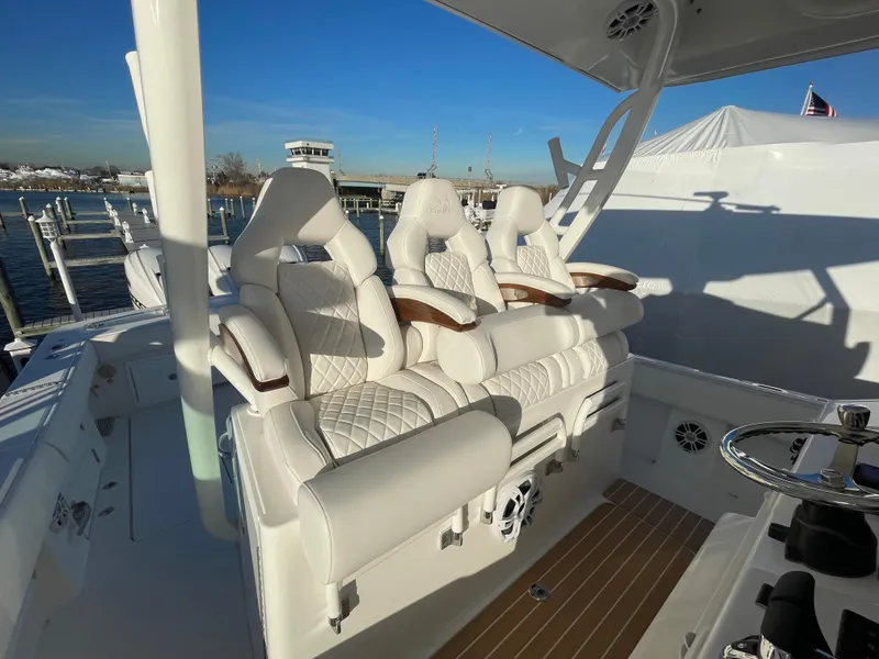 Slide: The Image of Luxurious seating on 2024 Regulator 37 boat, featuring plush white upholstery and elegant design. - 35
