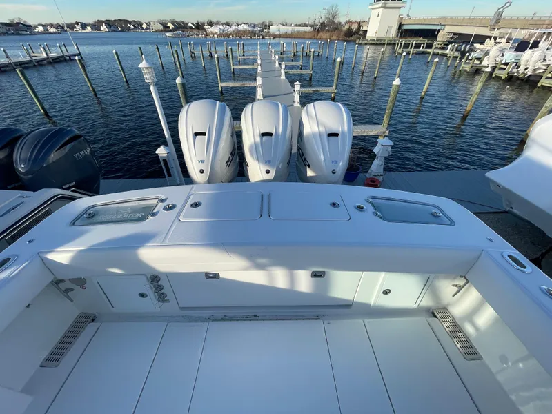 Slide: The Image of 2024 Regulator 37 boat with triple engines docked at a marina. - 36