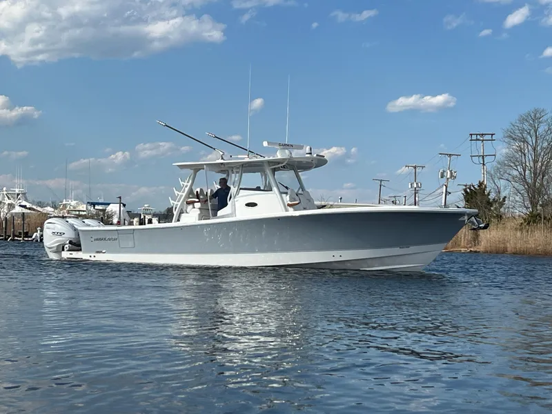 Slide: The Image of 2024 Regulator 37 boat on calm water under a clear blue sky. - 4