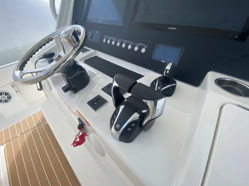 Slide: The Image of 2024 Regulator 37 boat helm with steering wheel and controls. - 41