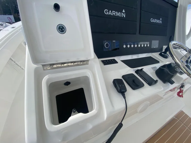 Slide: The Image of 2024 Regulator 37 boat dashboard with Garmin displays and control panel. - 43